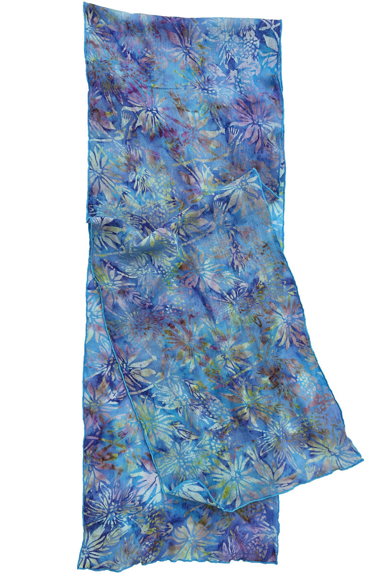A lightweight sheer scarf with a blue, purple, and teal floral batik print, shown flat.