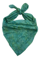 A green and teal batik-patterned scarf tied in a knot.