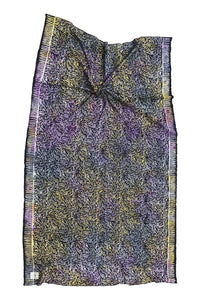 Colorful patterned fabric with fringe on a white background