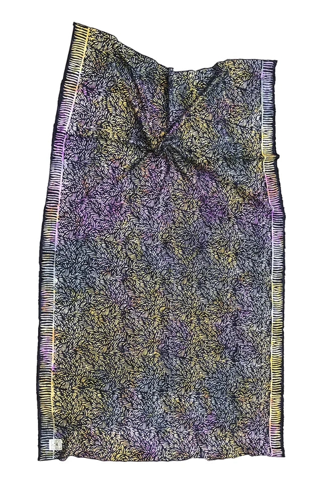 Colorful patterned fabric with fringe on a white background