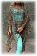 Woman wearing a floral patterned kimono-style garment over a turquoise outfit with a blurred background.