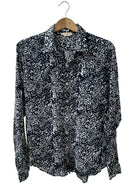 black and white batik printed shirt on a hanger