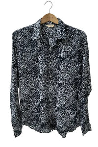 black and white batik printed shirt on a hanger