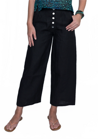 Person wearing black wide-leg pants with a buttoned front on a white background