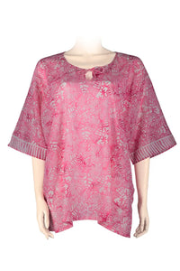 Pink floral patterned blouse on a mannequin -printed batik on cotton voile
